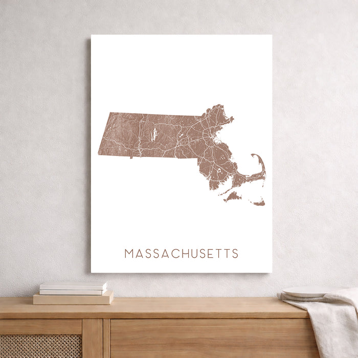 Map of Massachusetts on a white background, displayed on a wall above a wooden shelf.