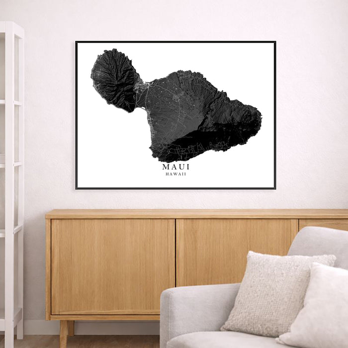 Framed map of Maui, Hawaii on a wall above a wooden cabinet and sofa.