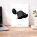 Art print of black map with 'MAUI HAWAII' text on a desk next to a laptop.