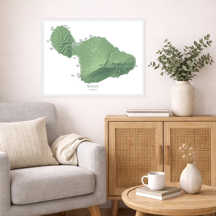Living room with a framed map of Maui on the wall, a beige sofa, wooden cabinet, and decorative items.