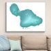 Framed map of Maui on a wall above a beige sofa with light blue pillows.