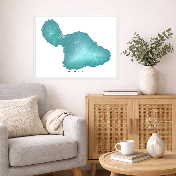 Living room with a framed map of Maui on the wall, a couch, and a side table with decor items.