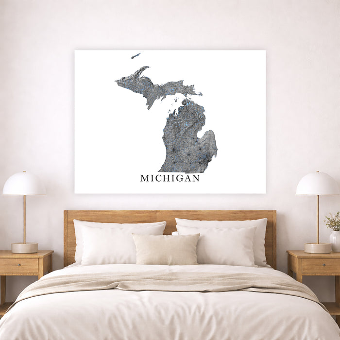 Map of Michigan on a wall above a bed in a bedroom setting