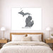Map of Michigan on a wall above a bed in a bedroom setting