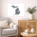 Living room with a map of Michigan on the wall, a couch, and a side table with decor items.