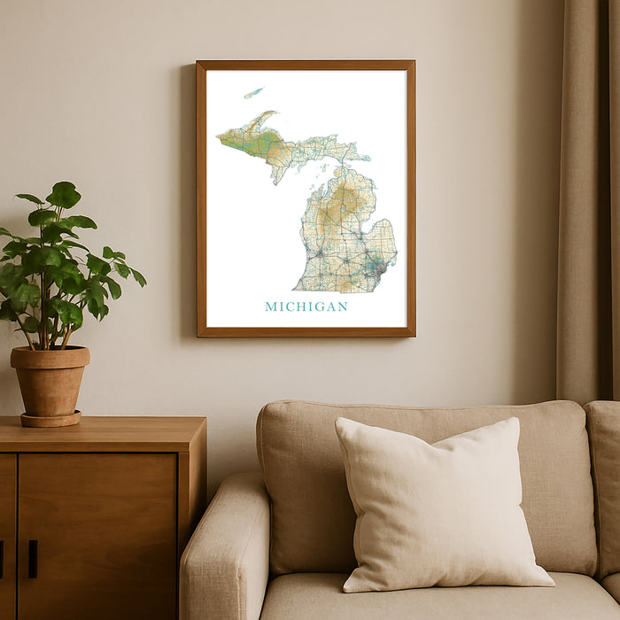 Framed map of Michigan on a wall above a beige sofa with a plant beside it.