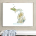 Framed map of Michigan on a wall above a white surface with a light gray towel.