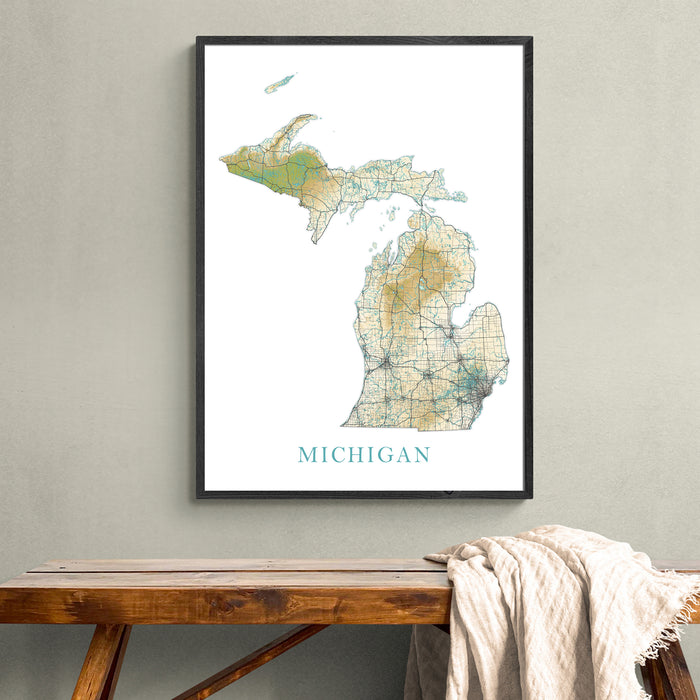 Framed map of Michigan on a wall above a wooden bench.
