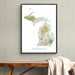 Framed map of Michigan on a wall above a wooden bench.