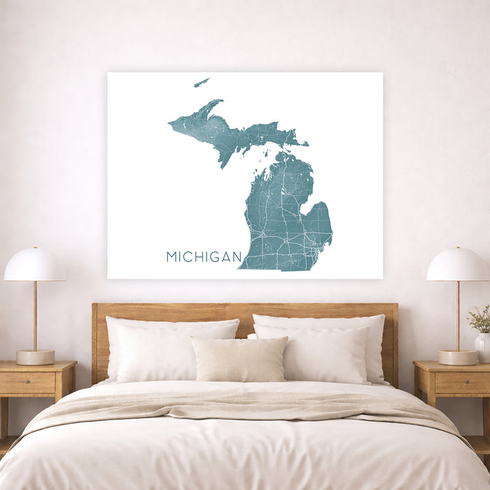 Map of Michigan on a wall above a bed in a bedroom setting