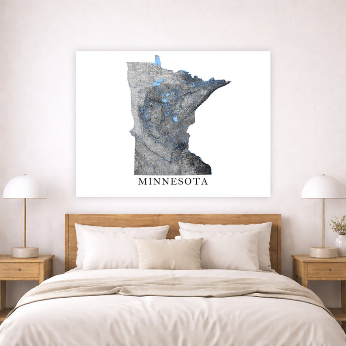 Map of Minnesota on a wall above a bed in a bedroom setting