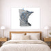 Map of Minnesota on a wall above a bed in a bedroom setting
