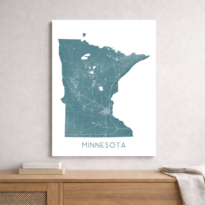 Map of Minnesota on a white wall above a wooden surface