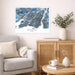 Living room with a Montreal map print on the wall, a beige armchair, wooden cabinet, and decorative items.