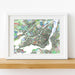Framed colorful map of Montreal on a white wall
