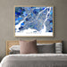 Framed map of Montreal above a bed with pillows and bedding.