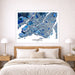 Map of Montreal on a wall above a bed in a bedroom setting