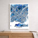 Map of Montreal framed on a wall above a wooden surface