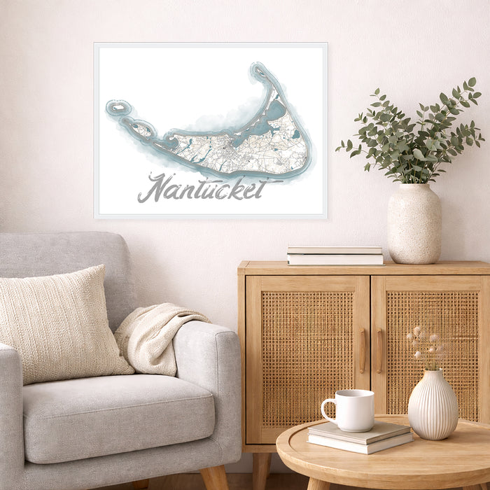 Living room with a framed map of Nantucket on the wall, a gray sofa, wooden cabinet, and small table.