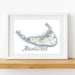 Framed map of Nantucket with a white border on a wooden surface.