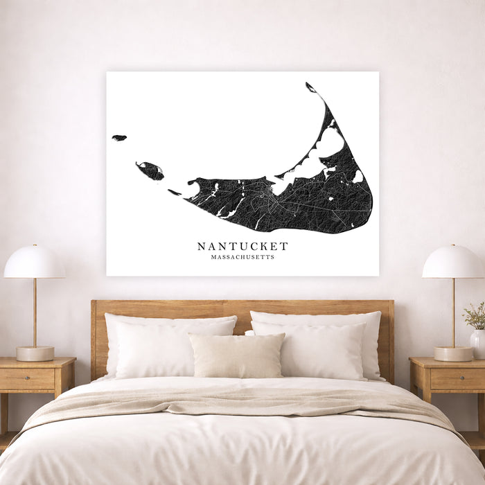 Map of Nantucket, Massachusetts on a wall above a bed in a bedroom.