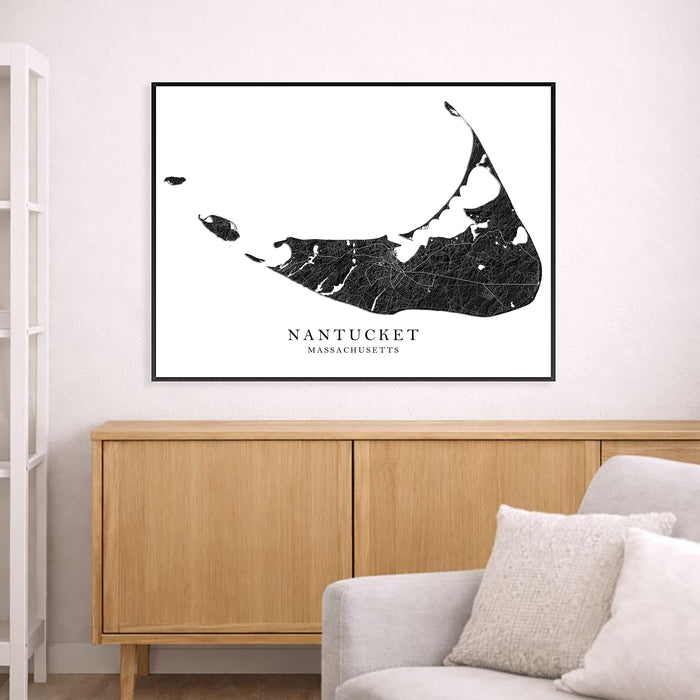 Framed map of Nantucket on a wall above a wooden cabinet and sofa.