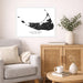 Living room with a map of Nantucket on the wall, a vase with greenery, and a wooden cabinet.