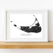 Framed black and white map of Nantucket, Massachusetts on a wooden shelf.