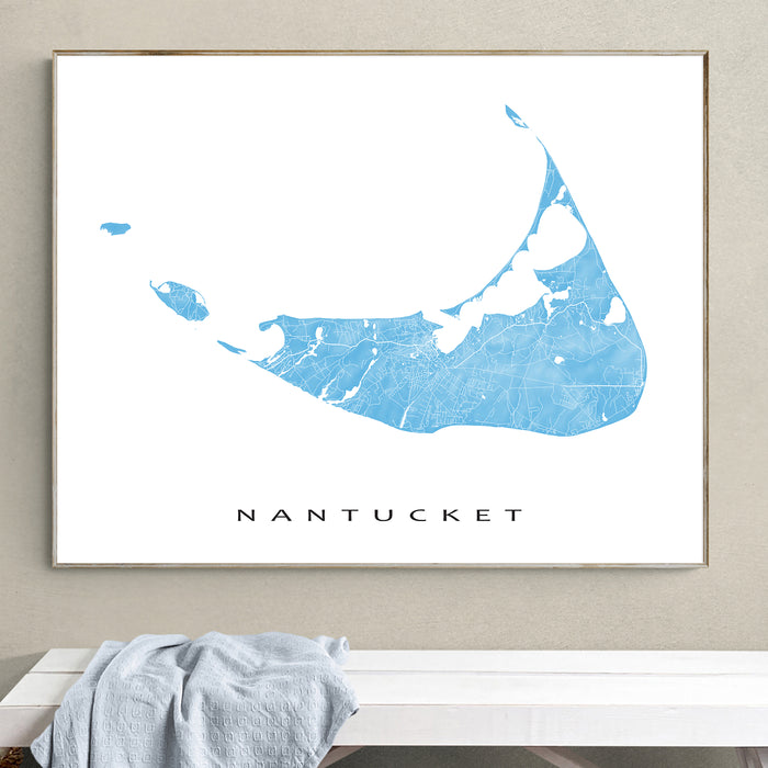 Framed map of Nantucket on a wall above a bench.
