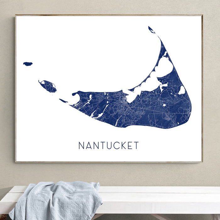Framed map of Nantucket on a wall above a white bench.