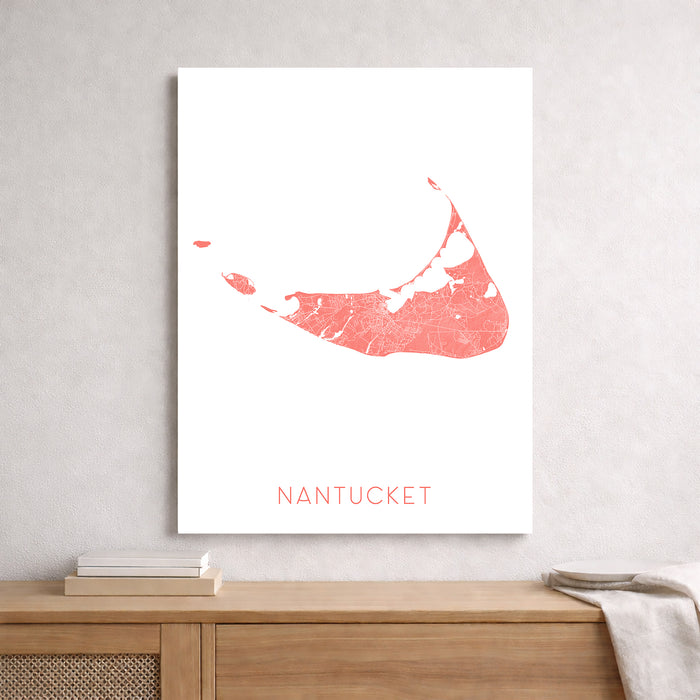 Framed map of Nantucket on a wall above a wooden shelf.