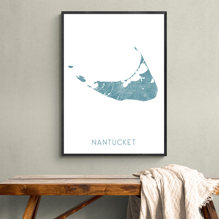 Framed map of Nantucket on a wall above a wooden bench.