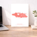 Map of Nassau on a white background next to a laptop on a wooden desk.