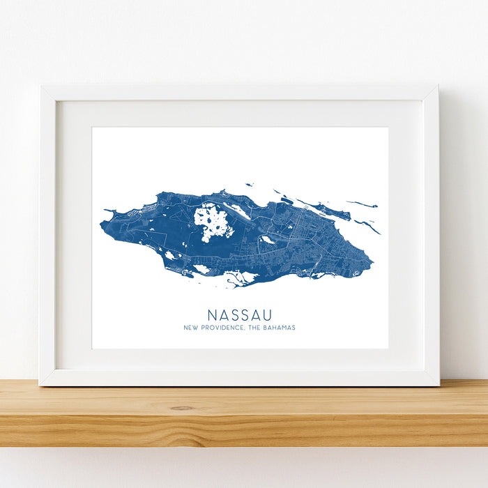 Framed map of Nassau, New Providence, The Bahamas on a white wall.