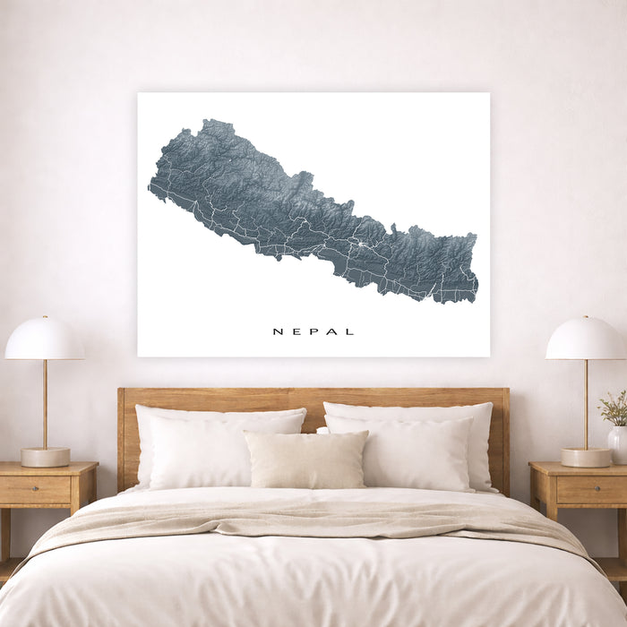 Map of Nepal on a wall above a bed in a bedroom setting