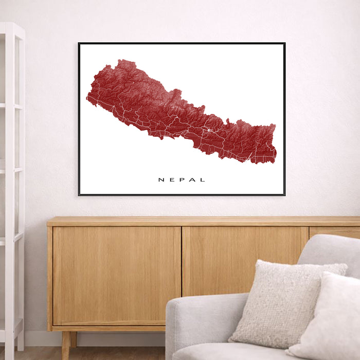 Map of Nepal framed on a wall above a wooden cabinet and sofa.