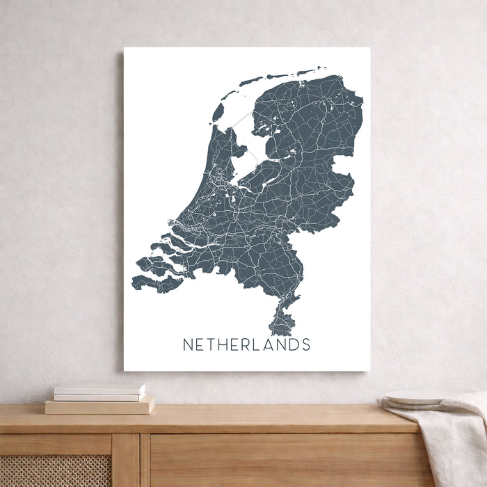 Map of the Netherlands on a white background above a wooden surface.