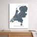 Map of the Netherlands on a white background above a wooden surface.