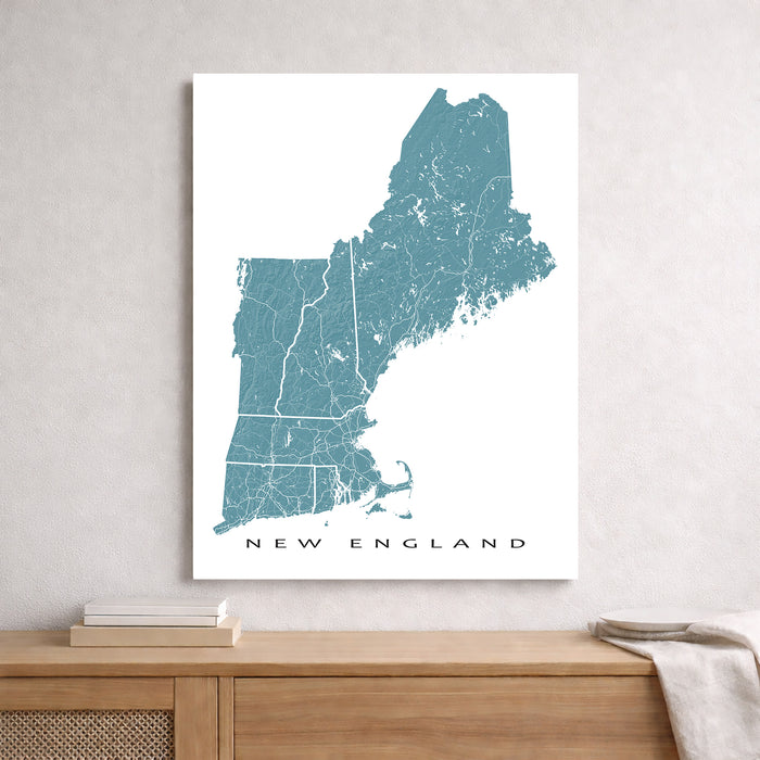 Map of New England on a white wall above a wooden surface