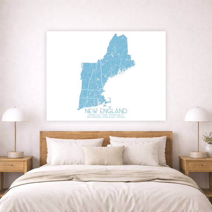 Map of New England on a wall above a bed in a bedroom.