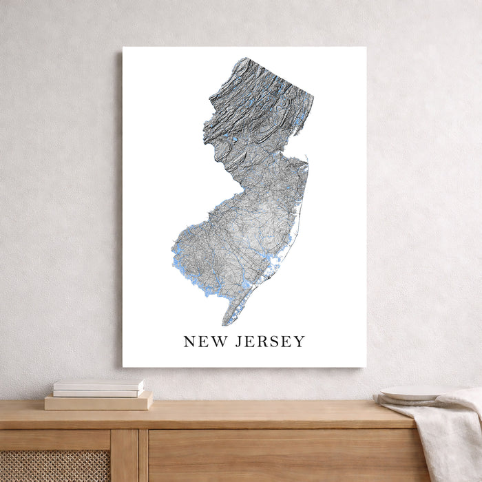 Map of New Jersey on a white wall above a wooden shelf.
