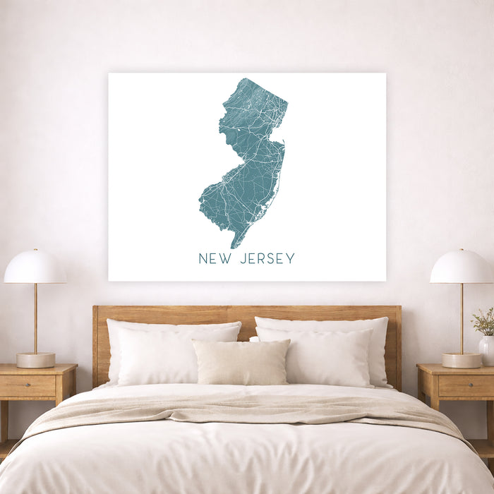 Map of New Jersey on a wall above a bed in a bedroom