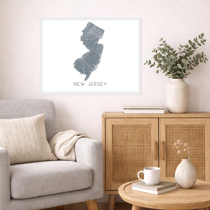 Living room with a map of New Jersey on the wall, a couch, and a side table with decor items.