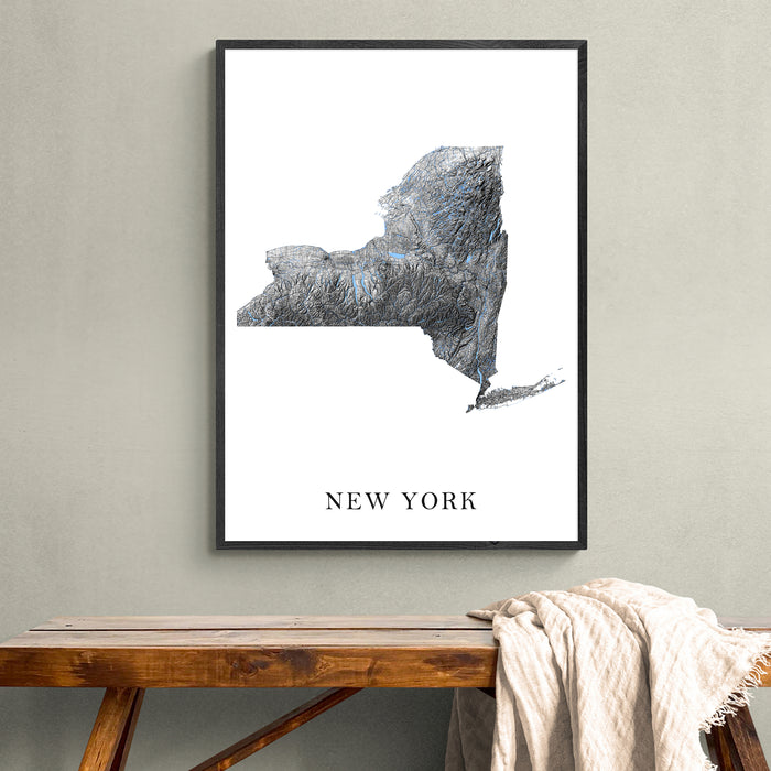 Framed map of New York on a wall above a wooden bench.