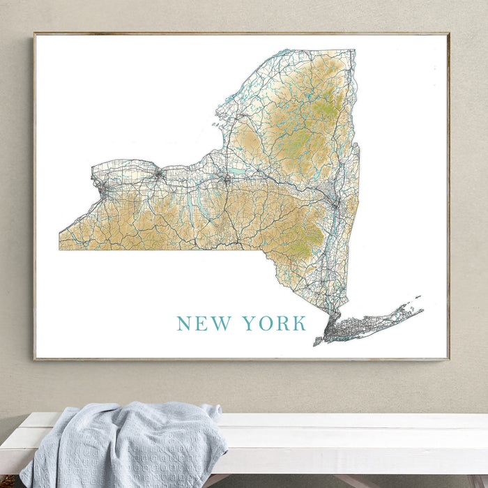 Framed map of New York on a wall above a white surface with a gray towel.