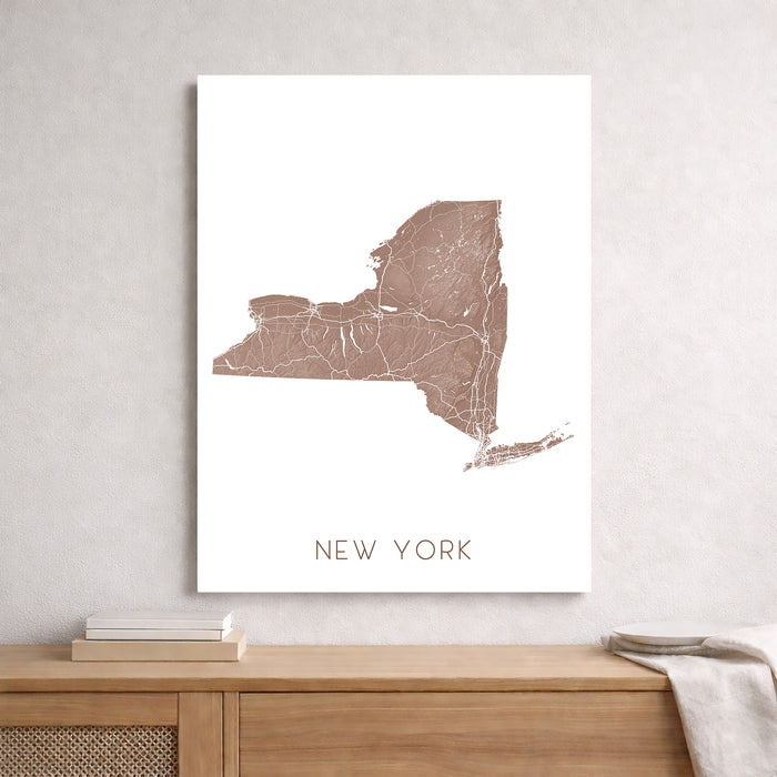 Map of New York on a white wall above a wooden shelf.