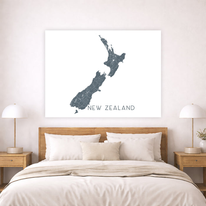 Map of New Zealand on a wall above a bed in a bedroom