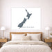 Map of New Zealand on a wall above a bed in a bedroom