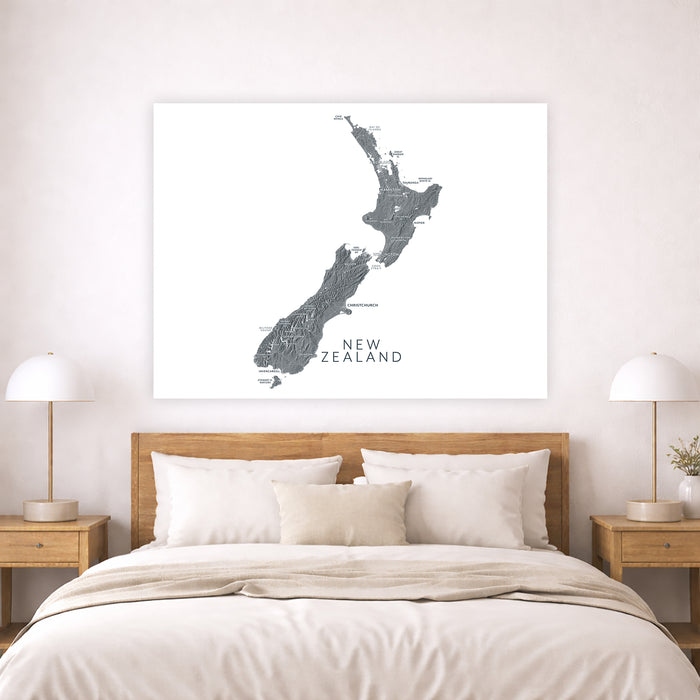 Map of New Zealand on a wall above a bed in a bedroom setting