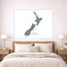 Map of New Zealand on a wall above a bed in a bedroom setting